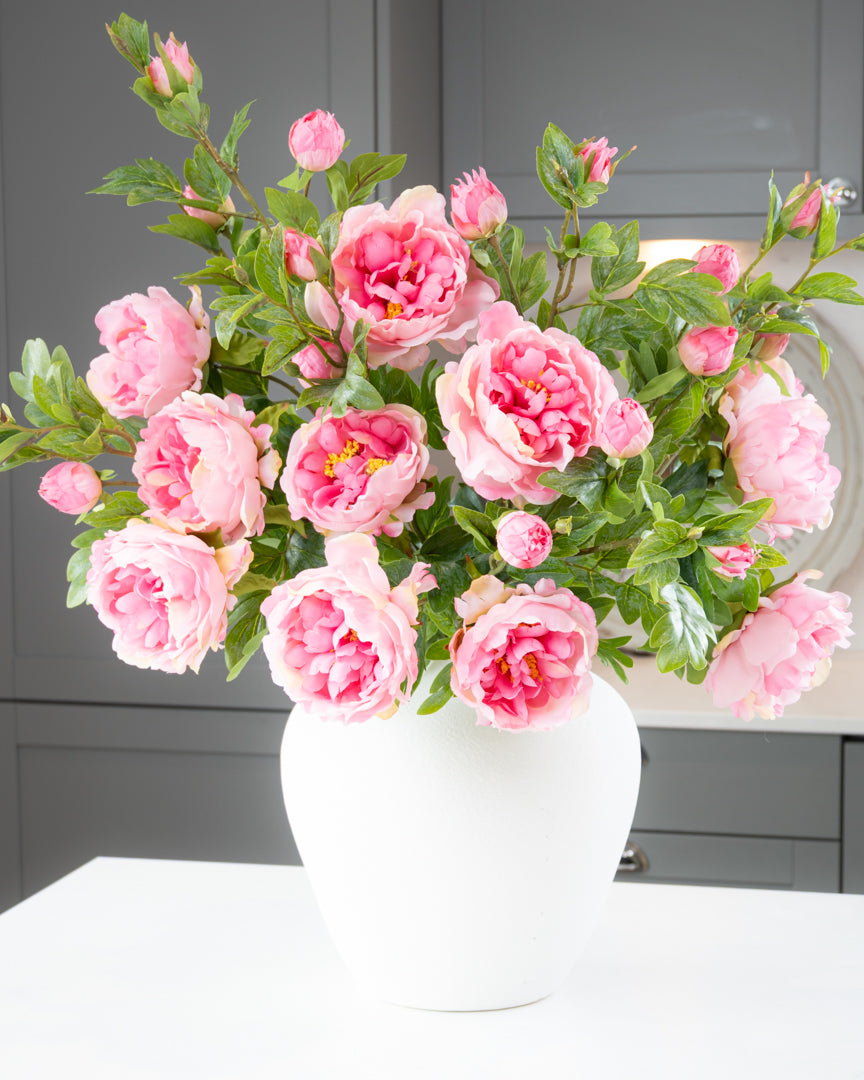 Pink peony bouquet in a white vase